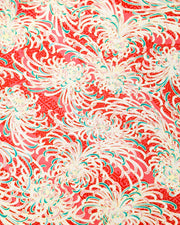 Japanese chiyogami paper featuring red, green, and white chrysanthemums on a red background with metallic gold details. 