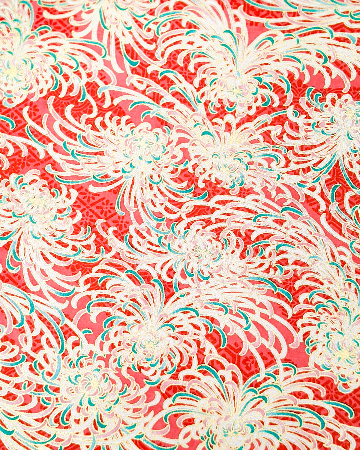 Japanese chiyogami paper featuring red, green, and white chrysanthemums on a red background with metallic gold details. 