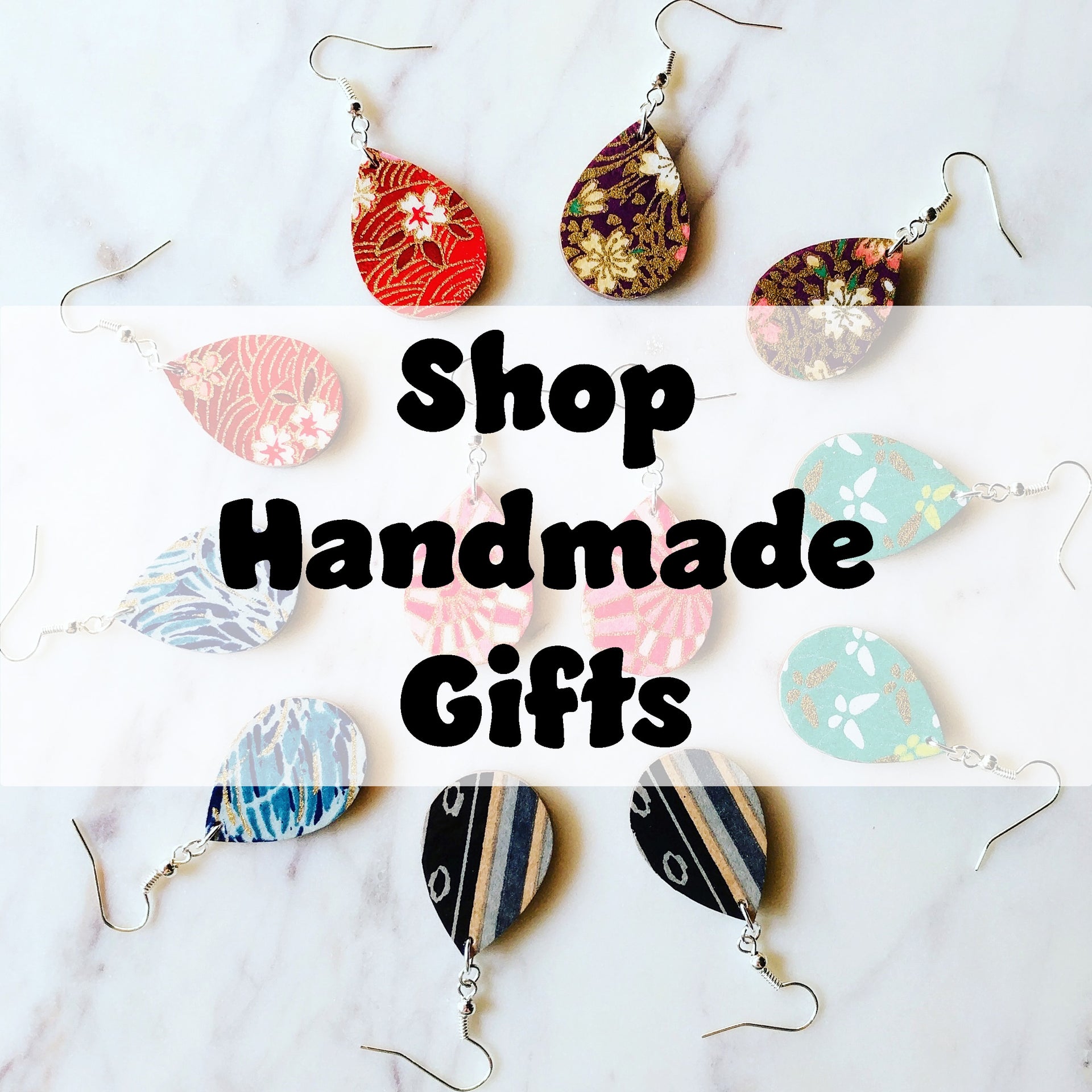 Collection of handmade Japanese-inspired gifts including wooden origami ornaments, jewelry, and accessories.