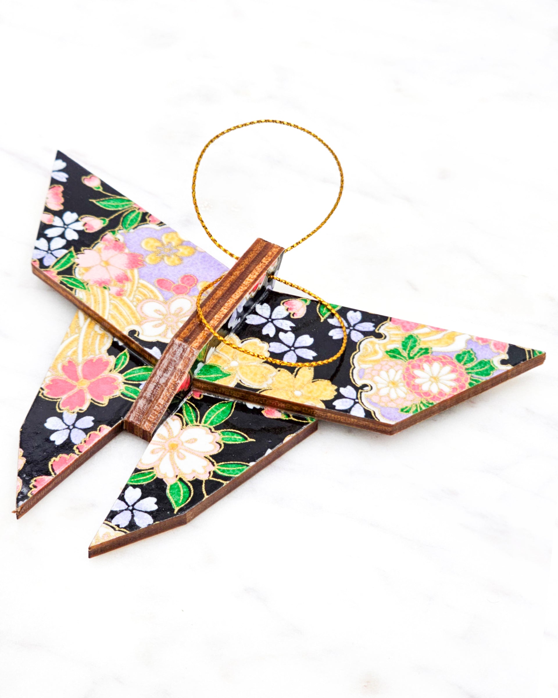 Large wooden origami butterfly ornament featuring pink, yellow, purple, and white cherry blossoms and purple yukiwa on a black background with metallic gold details.