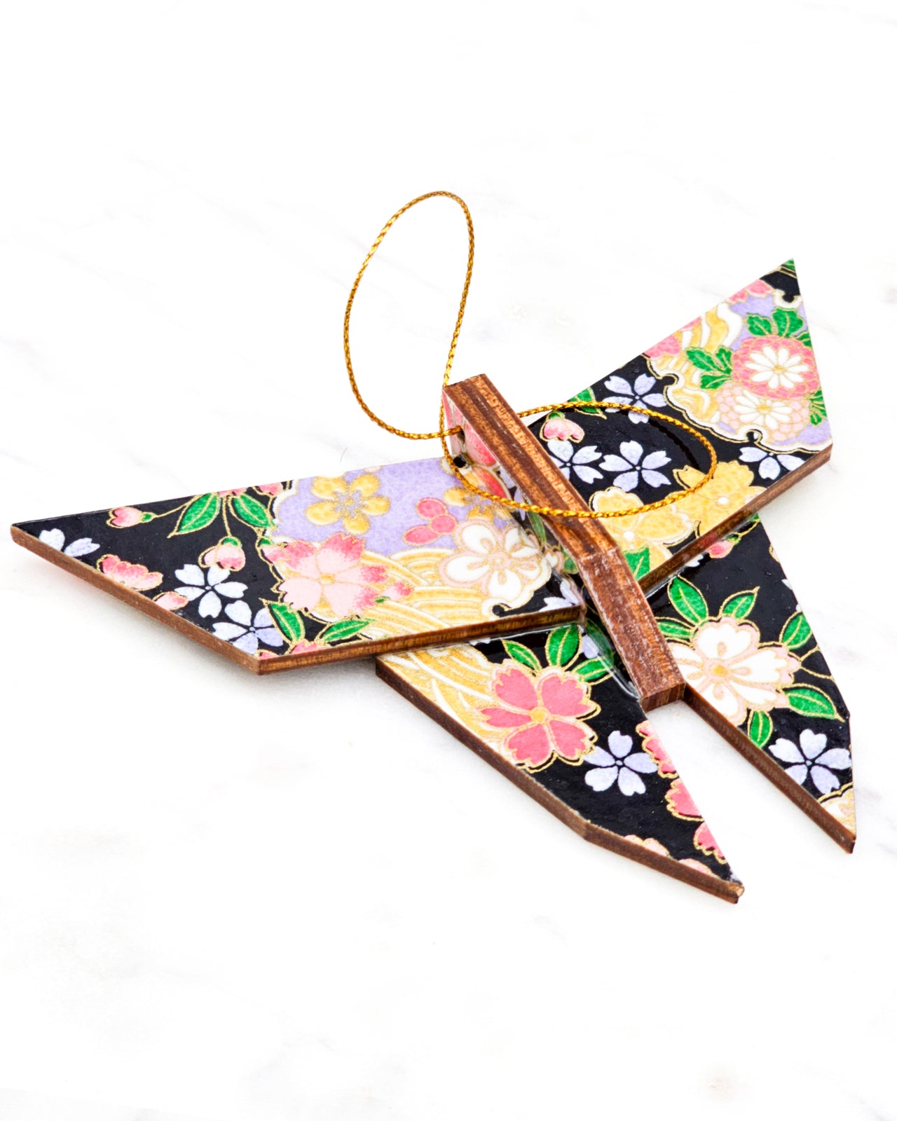 Large wooden origami butterfly ornament featuring pink, yellow, purple, and white cherry blossoms and purple yukiwa on a black background with metallic gold details.