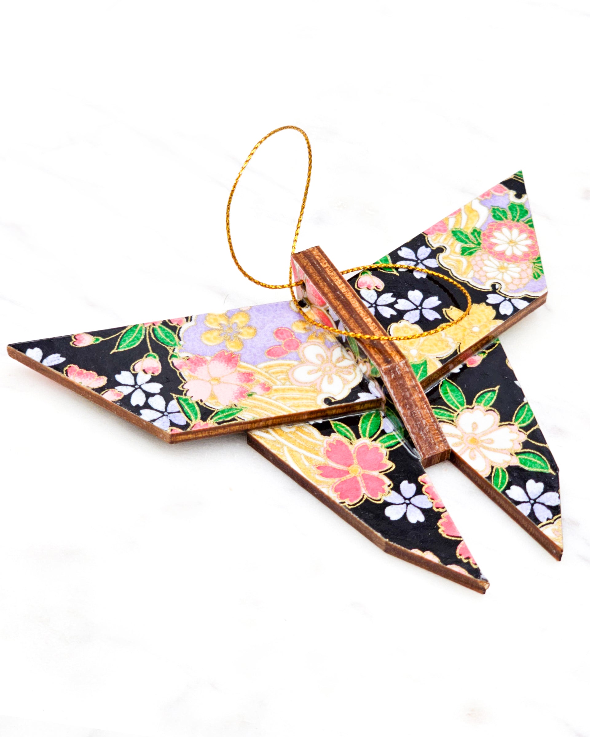 Large wooden origami butterfly ornament featuring pink, yellow, purple, and white cherry blossoms and purple yukiwa on a black background with metallic gold details.