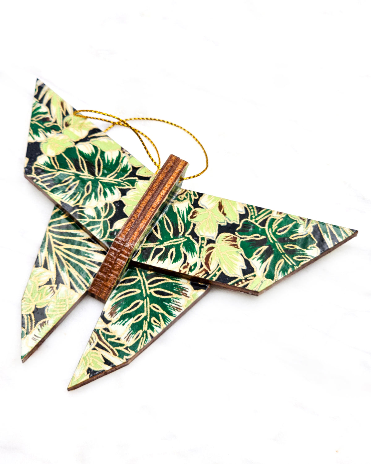 Large wooden origami butterfly ornament featuring green and brown frond leaves on a black background with metallic gold details.