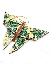 Large wooden origami butterfly ornament featuring green and brown frond leaves on a black background with metallic gold details.