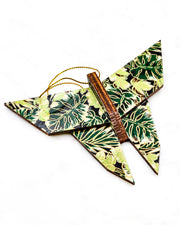 Large wooden origami butterfly ornament featuring green and brown frond leaves on a black background with metallic gold details.