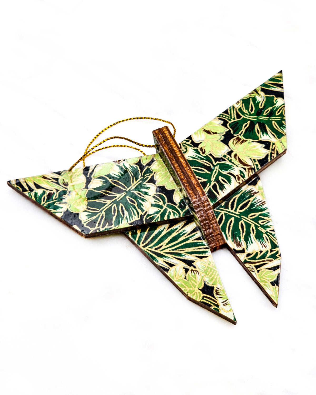 Large wooden origami butterfly ornament featuring green and brown frond leaves on a black background with metallic gold details.