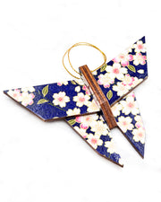 Large wooden origami butterfly ornament featuring pink and white cherry blossoms on a dark blue background with metallic gold details.