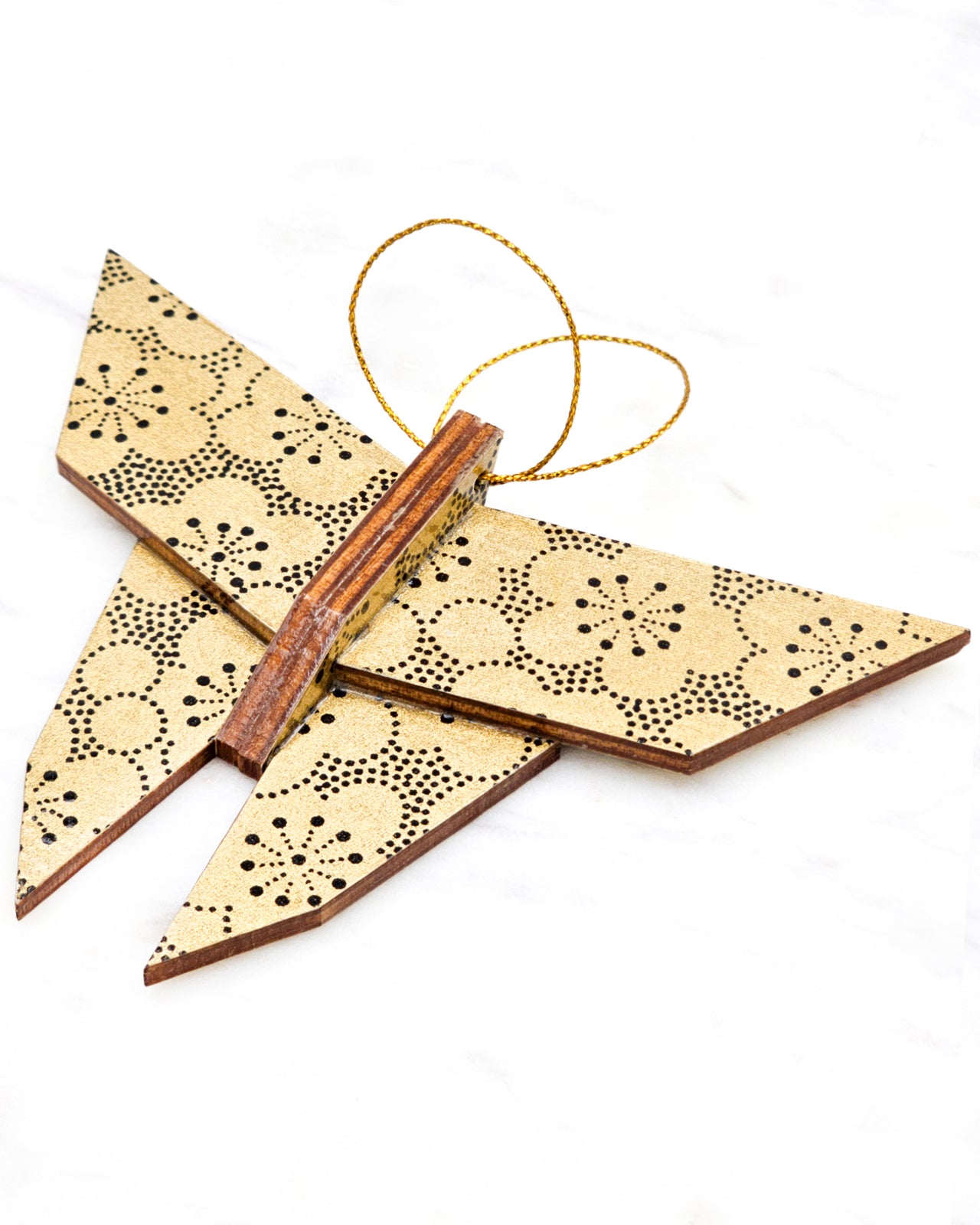 Large wooden origami butterfly ornament featuring black pointillistic plum blossoms on a metallic gold background.