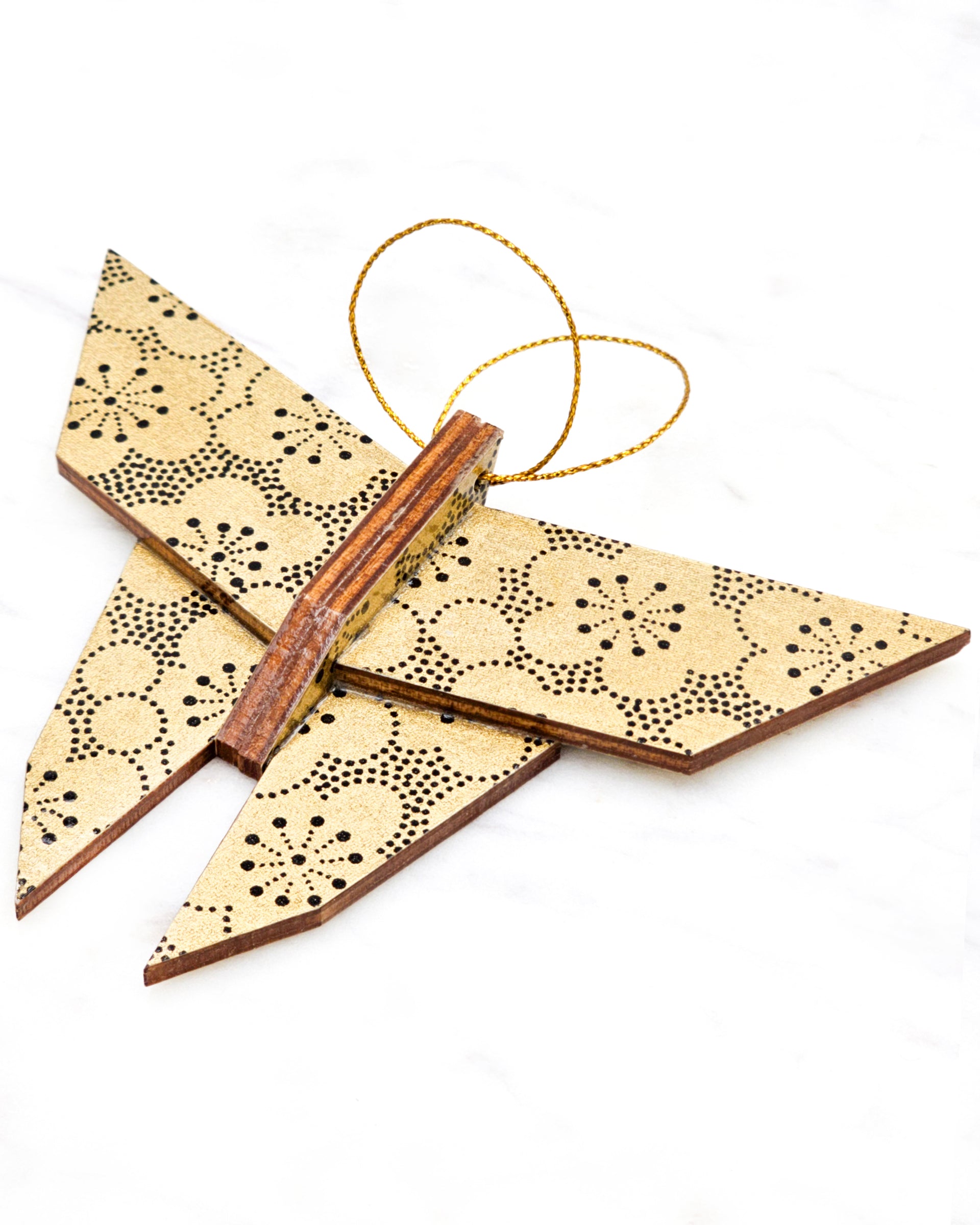 Large wooden origami butterfly ornament featuring black pointillistic plum blossoms on a metallic gold background.