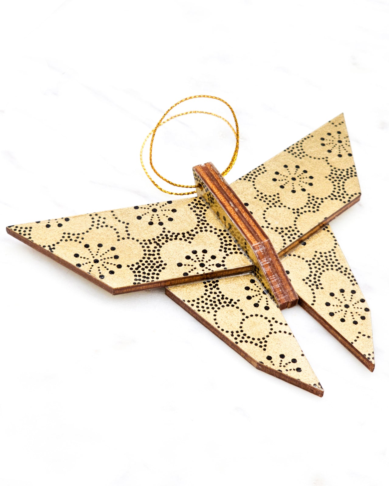 Large wooden origami butterfly ornament featuring black pointillistic plum blossoms on a metallic gold background.