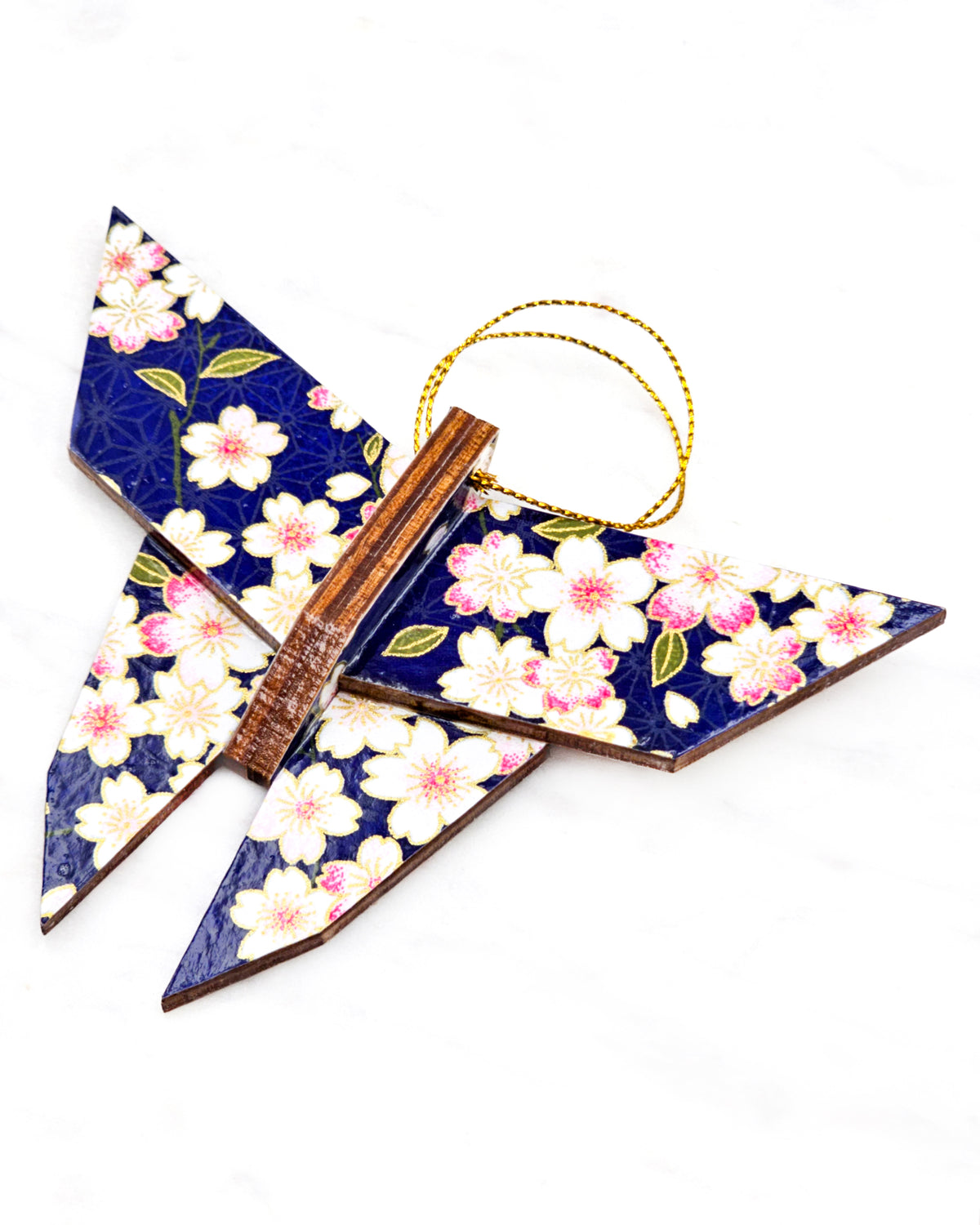 Large wooden origami butterfly ornament featuring pink and white cherry blossoms on a dark blue background with metallic gold details.