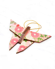 Small wooden origami butterfly ornament featuring pink, white, and red chrysanthemums with green leaves on a pink background with metallic gold accents.