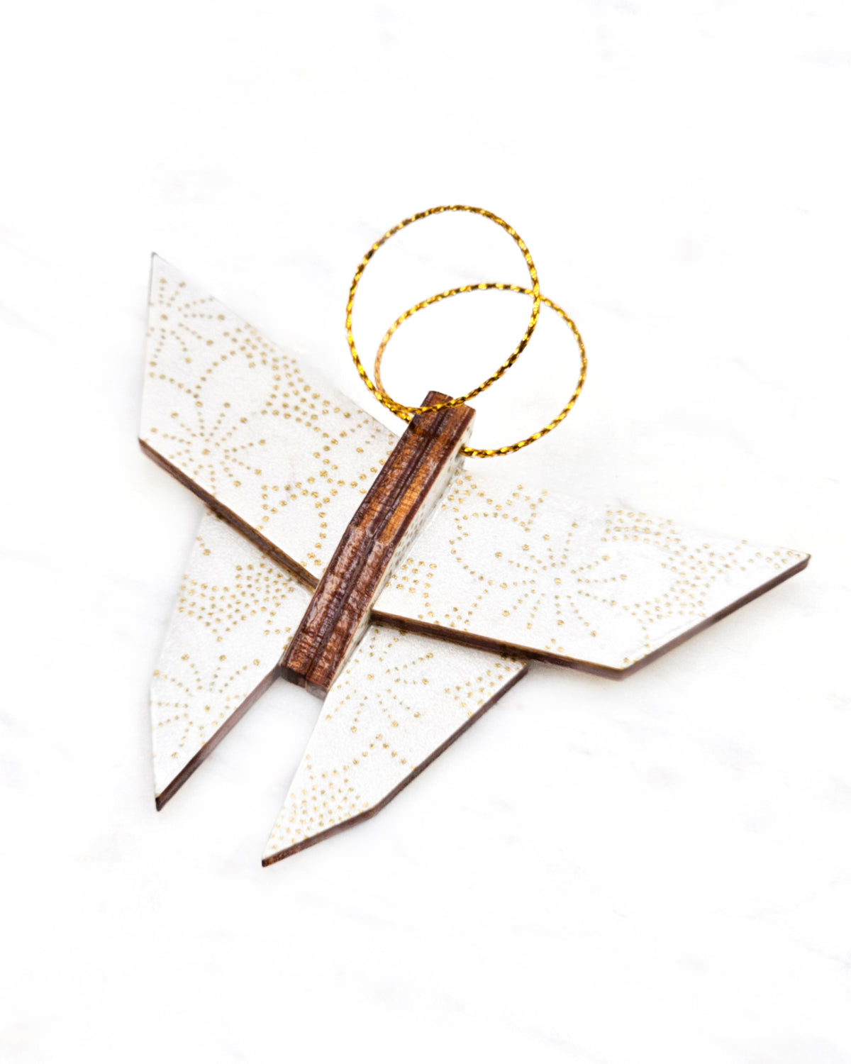 Small wooden origami butterfly ornament featuring metallic gold pointillistic cherry blossoms on a white background.