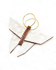Small wooden origami butterfly ornament featuring metallic gold pointillistic cherry blossoms on a white background.