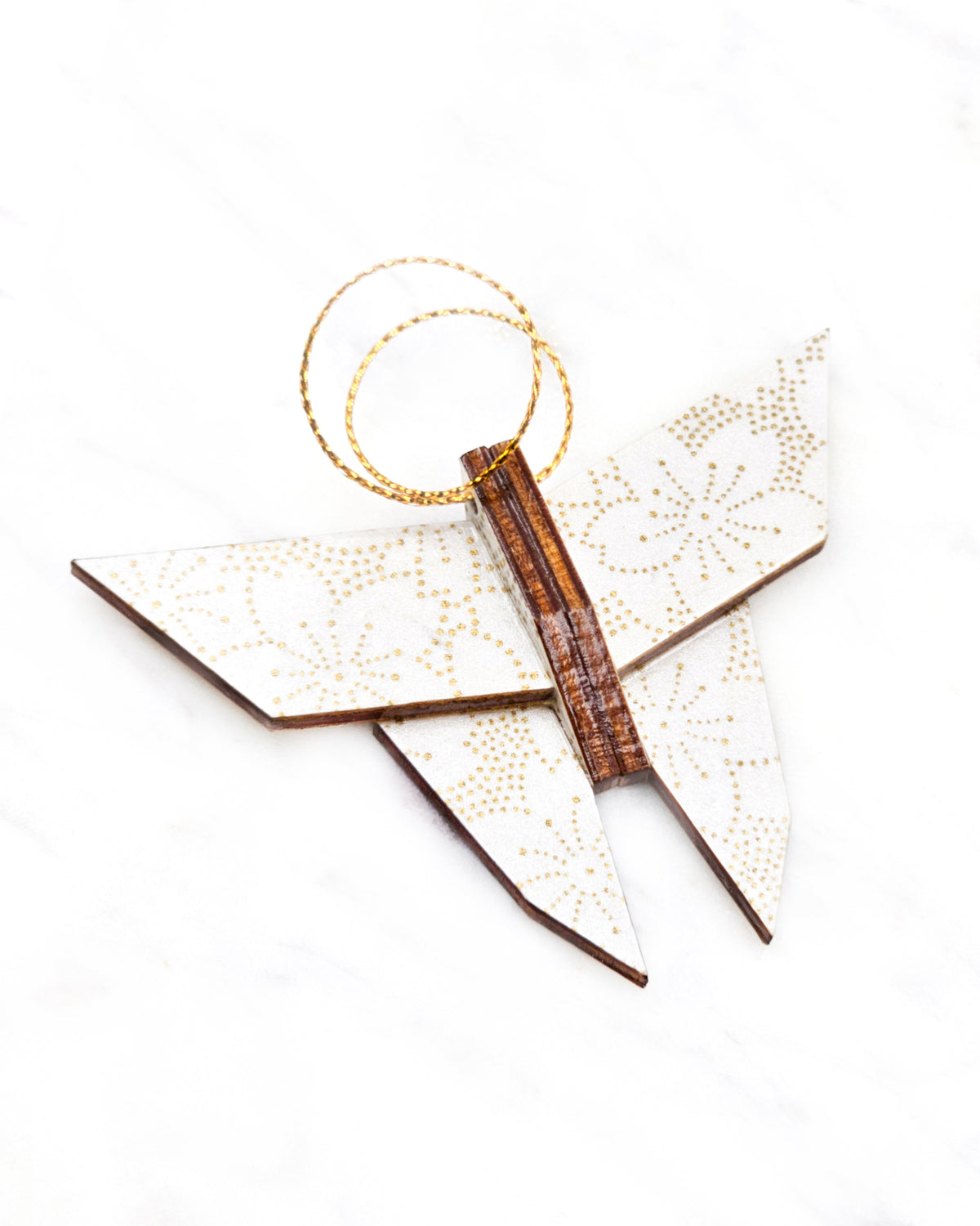 Small wooden origami butterfly ornament featuring metallic gold pointillistic cherry blossoms on a white background.