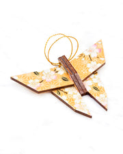 Small wooden origami butterfly ornament featuring pink and white cherry blossoms on an orange background with metallic gold details.