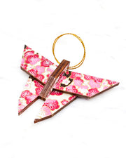 Small wooden origami butterfly ornament featuring pink and white plum blossoms with dark brown branches on a white background with metallic gold details.