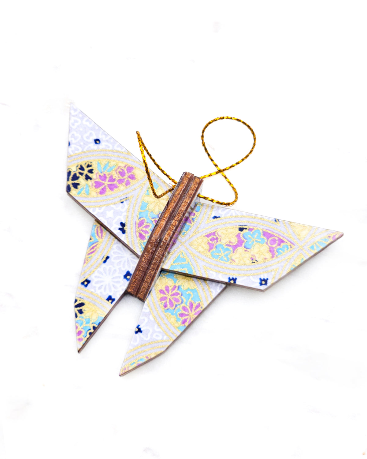 Small wooden origami butterfly ornament featuring a blue, yellow, and purple shippo design filled with assorted floral and geometric designs on a light purple background with metallic gold details.