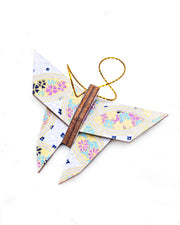 Small wooden origami butterfly ornament featuring a blue, yellow, and purple shippo design filled with assorted floral and geometric designs on a light purple background with metallic gold details.