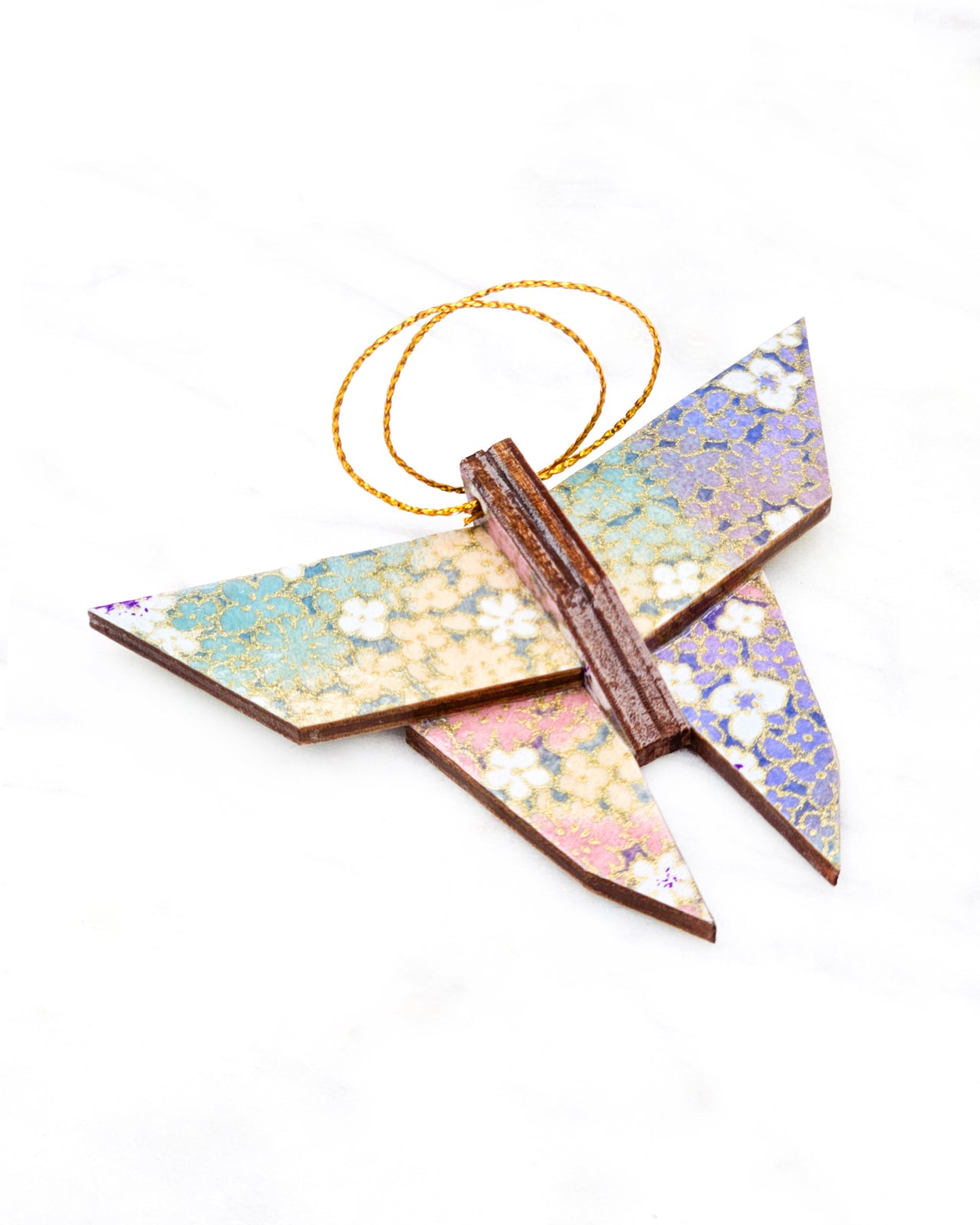 Small wooden origami butterfly ornament featuring small rainbow-colored flowers with metallic gold details.