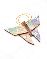 Small wooden origami butterfly ornament featuring small rainbow-colored flowers with metallic gold details.