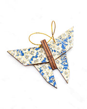 Small wooden origami butterfly ornament featuring white cherry blossoms on a blue background with metallic gold details.