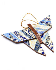 Wooden origami butterfly ornament featuring blue floral ribbons on a beige background with metallic gold accents.