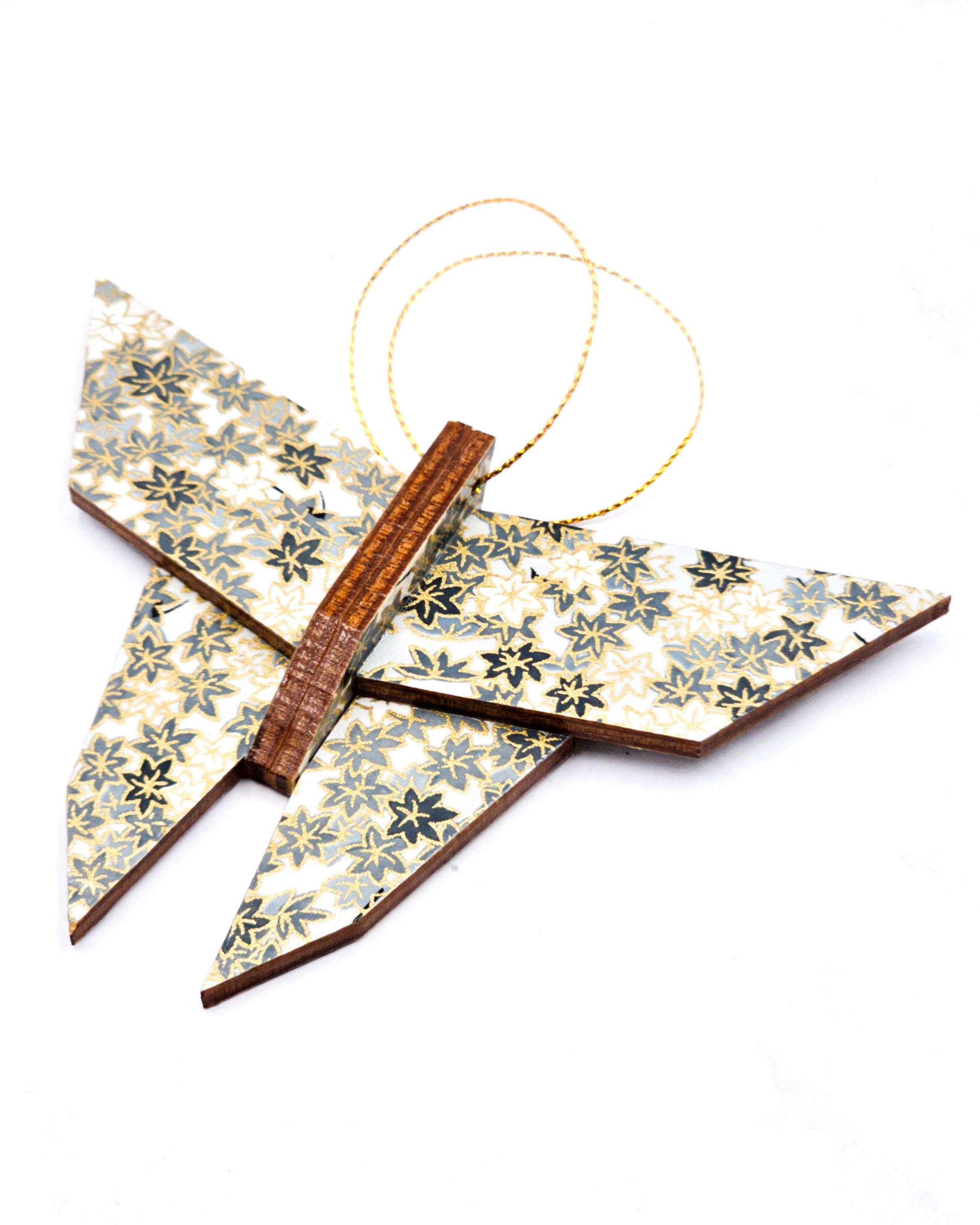 Wooden origami butterfly ornament featuring gray and white maple leaves on a gray background with metallic gold accents.