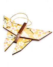 Wooden origami butterfly ornament featuring pink and white cherry blossoms on an orange background with metallic gold accents.