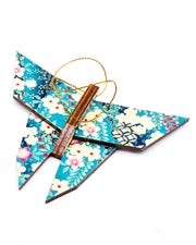 Wooden origami butterfly ornament featuring pink, white, and cream plum blossoms with blue wisteria on a teal and blue background with metallic gold accents.