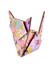 Wooden origami cat ornament featuring pink cherry blossoms and blue yukiwa (snowflakes) on a purple background with metallic gold accents.