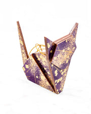 Large wooden origami cat ornament featuring scattered metallic gold geometric shapes and fine gold lines on a dark purple background.