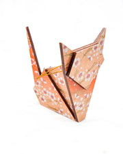 Large wooden origami cat ornament featuring small white plum blossoms and matsuba (pine needles) on an orange gradient background with metallic gold details.
