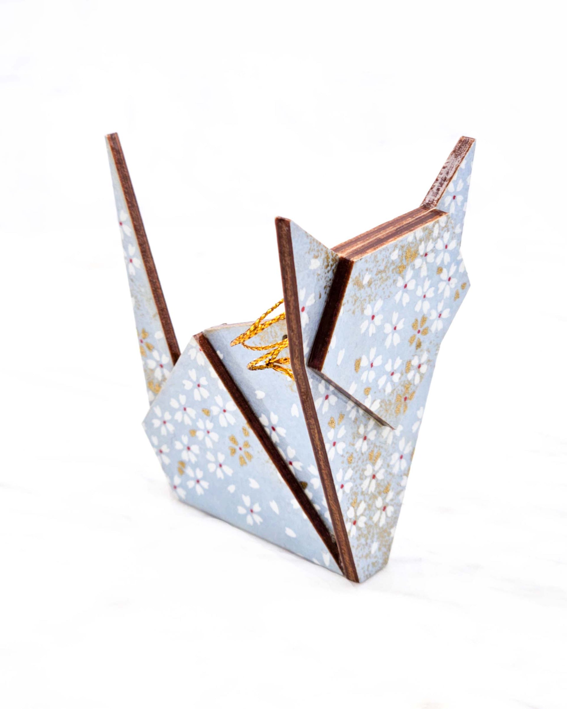 Large wooden origami cat ornament featuring small white and gold cherry blossoms on a light blue background with metallic gold accents.
