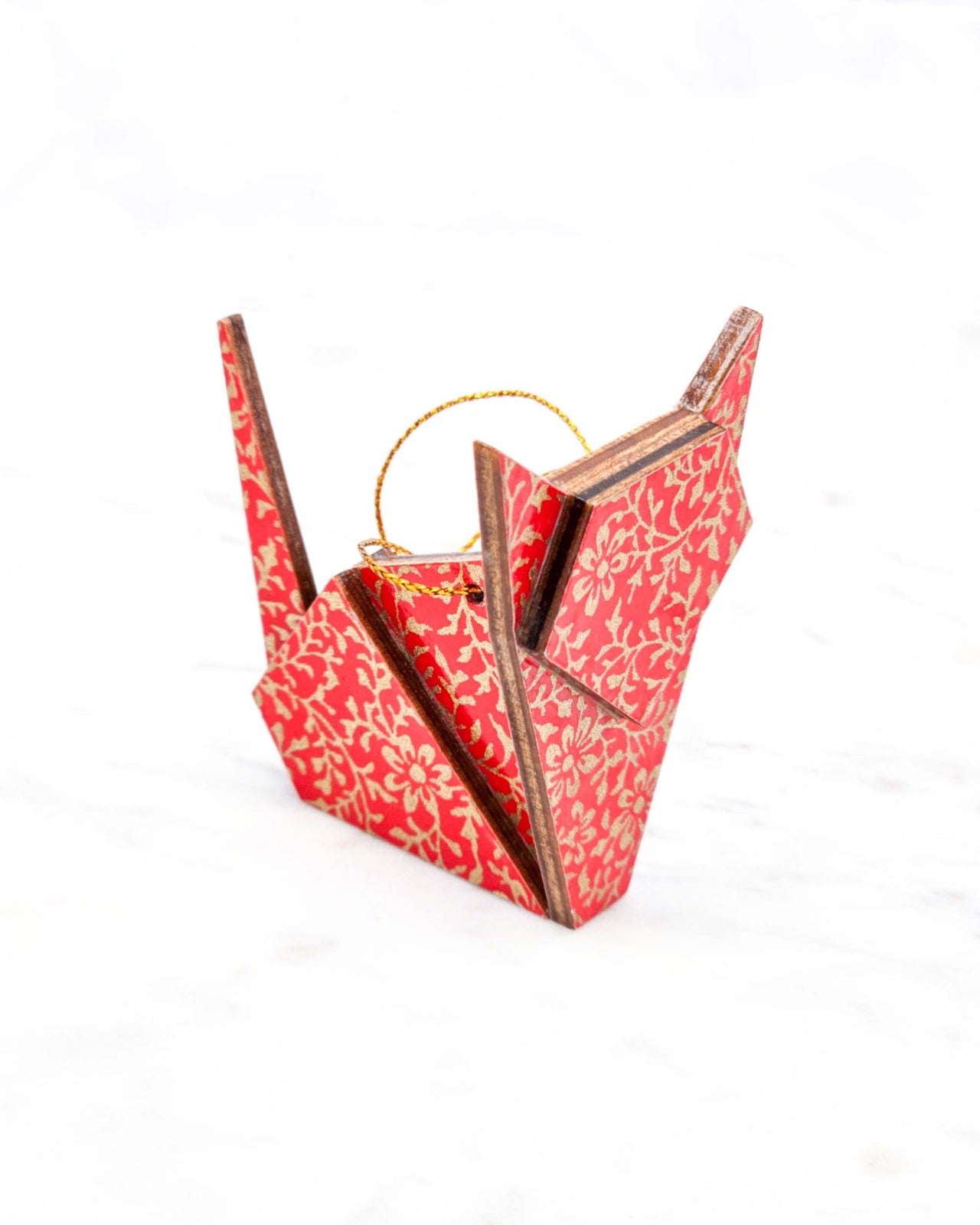 Small wooden origami cat ornament featuring a metallic gold floral motif on a bright red background.