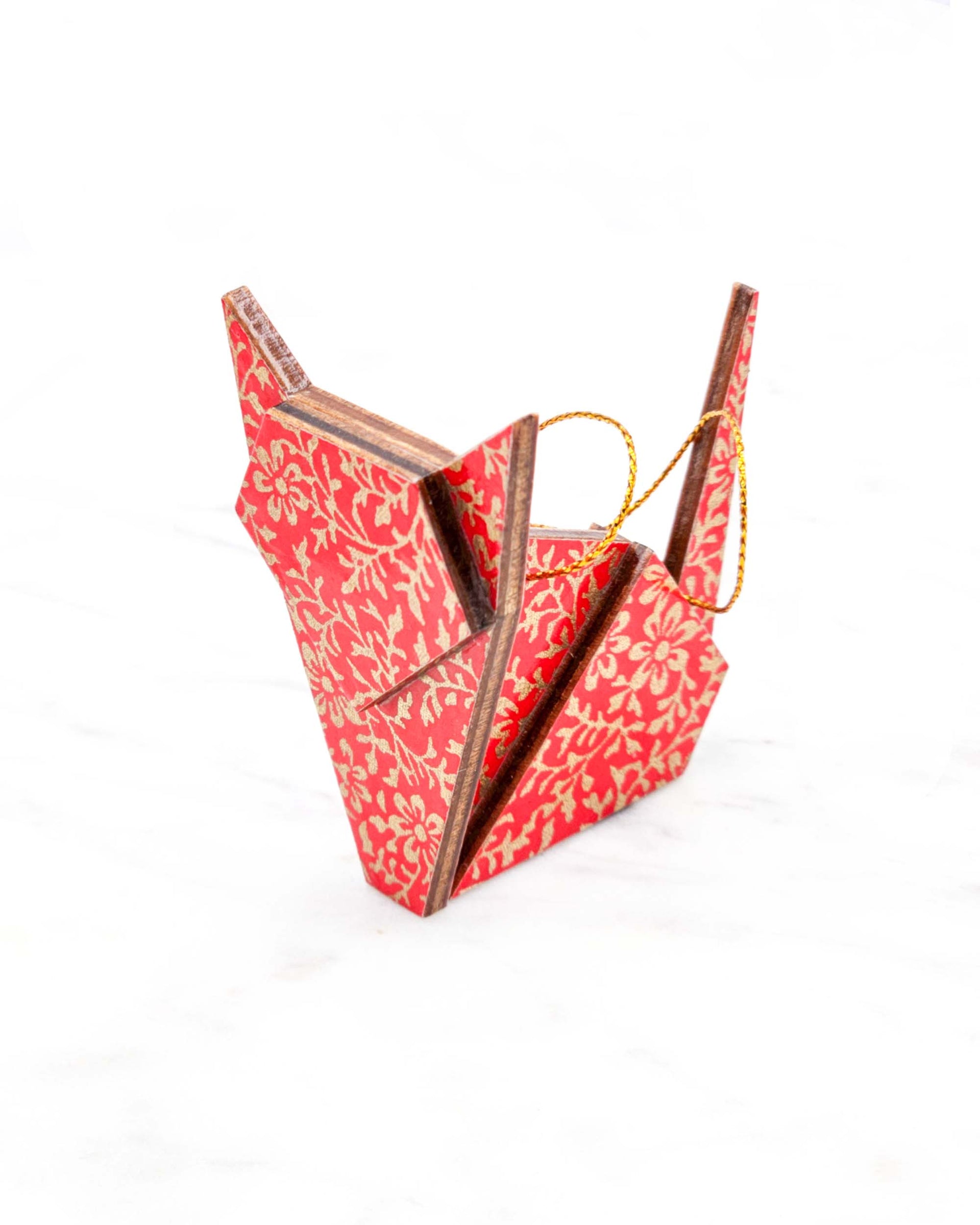 Small wooden origami cat ornament featuring a metallic gold floral motif on a bright red background.
