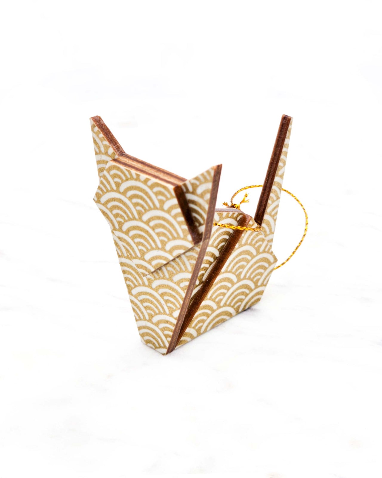 Small wooden origami cat ornament featuring a traditional white and metallic gold seigaiha (wave crests) pattern.