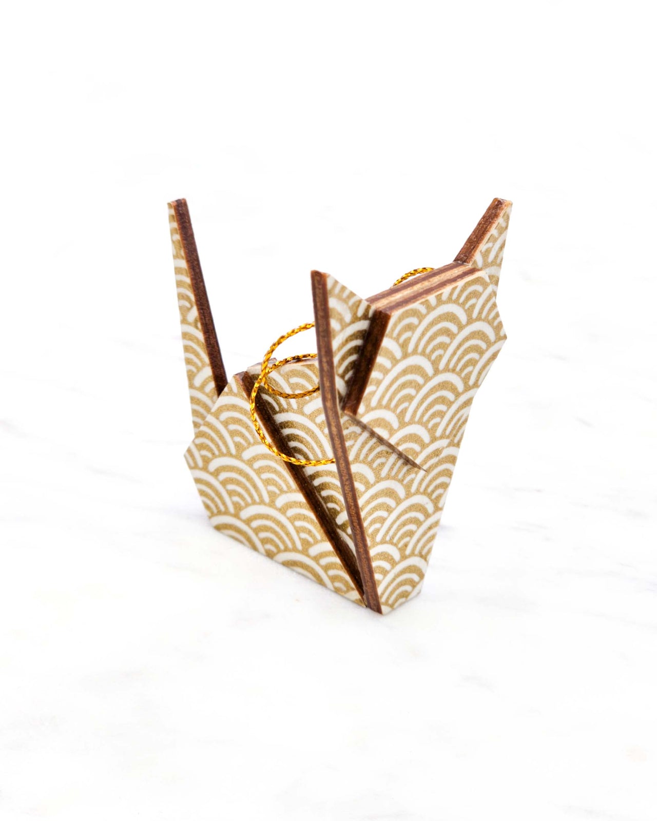 Small wooden origami cat ornament featuring a traditional white and metallic gold seigaiha (wave crests) pattern.