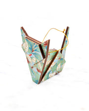 Small wooden origami cat ornament featuring green, white, red, and silver leaves on a light blue background with metallic gold details.