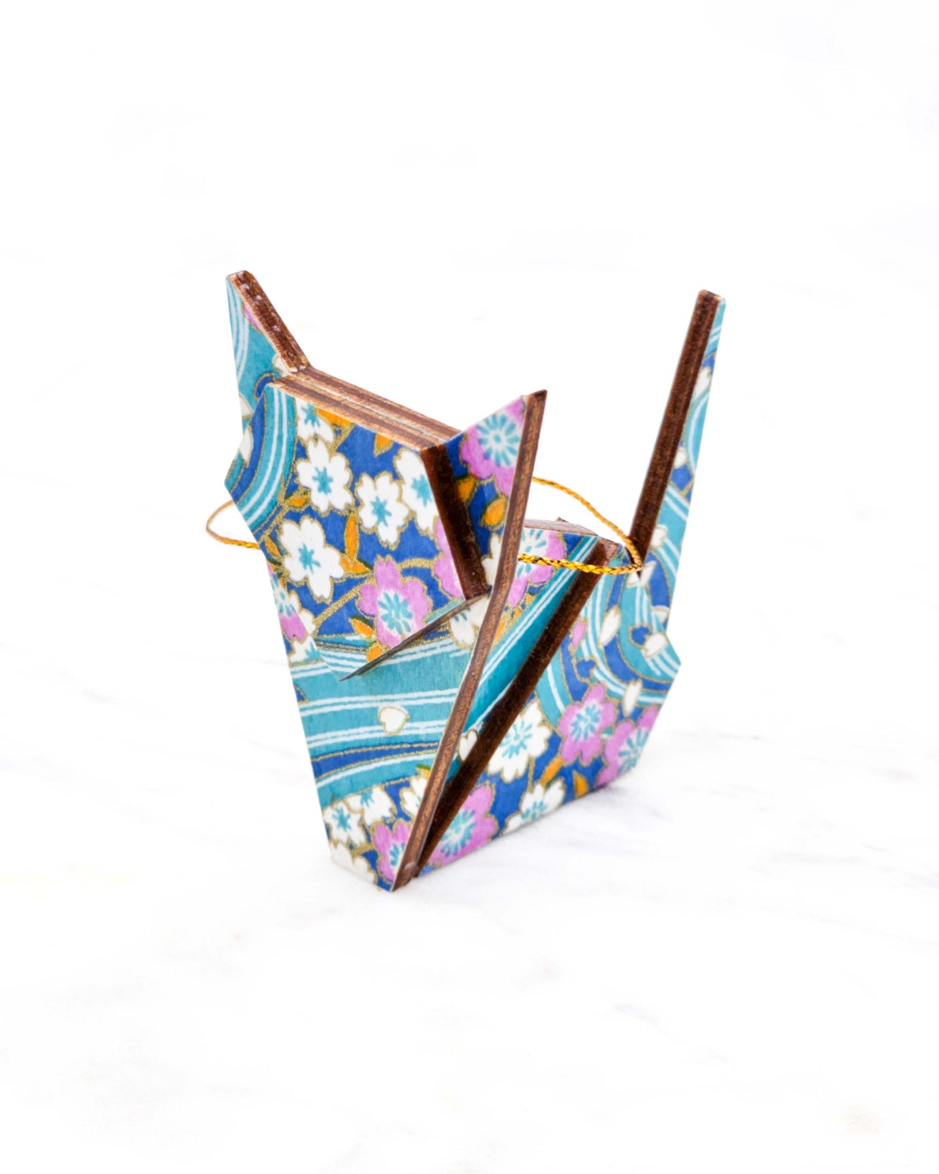 Small wooden origami cat ornament featuring pink and white cherry blossoms on a blue background with metallic gold details.
