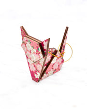 Small wooden origami cat ornament featuring pink and white cherry blossoms on a pink background with metallic gold details.