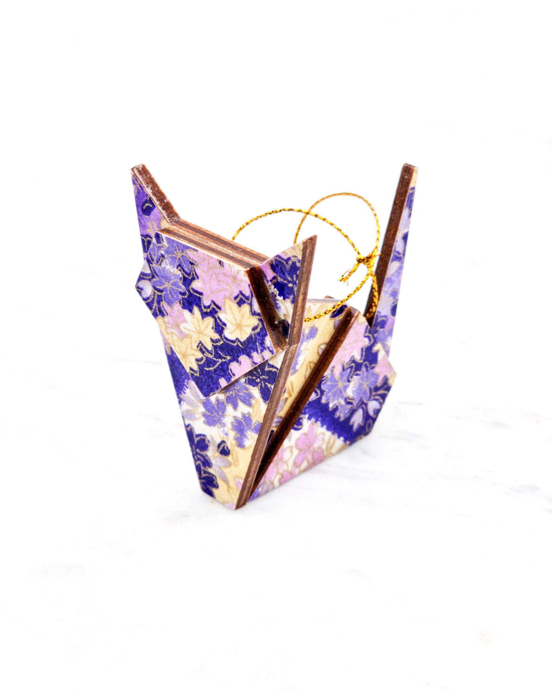 Small wooden origami cat ornament featuring purple and yellow flowers and maple leaves on a purple and white background with metallic gold details.