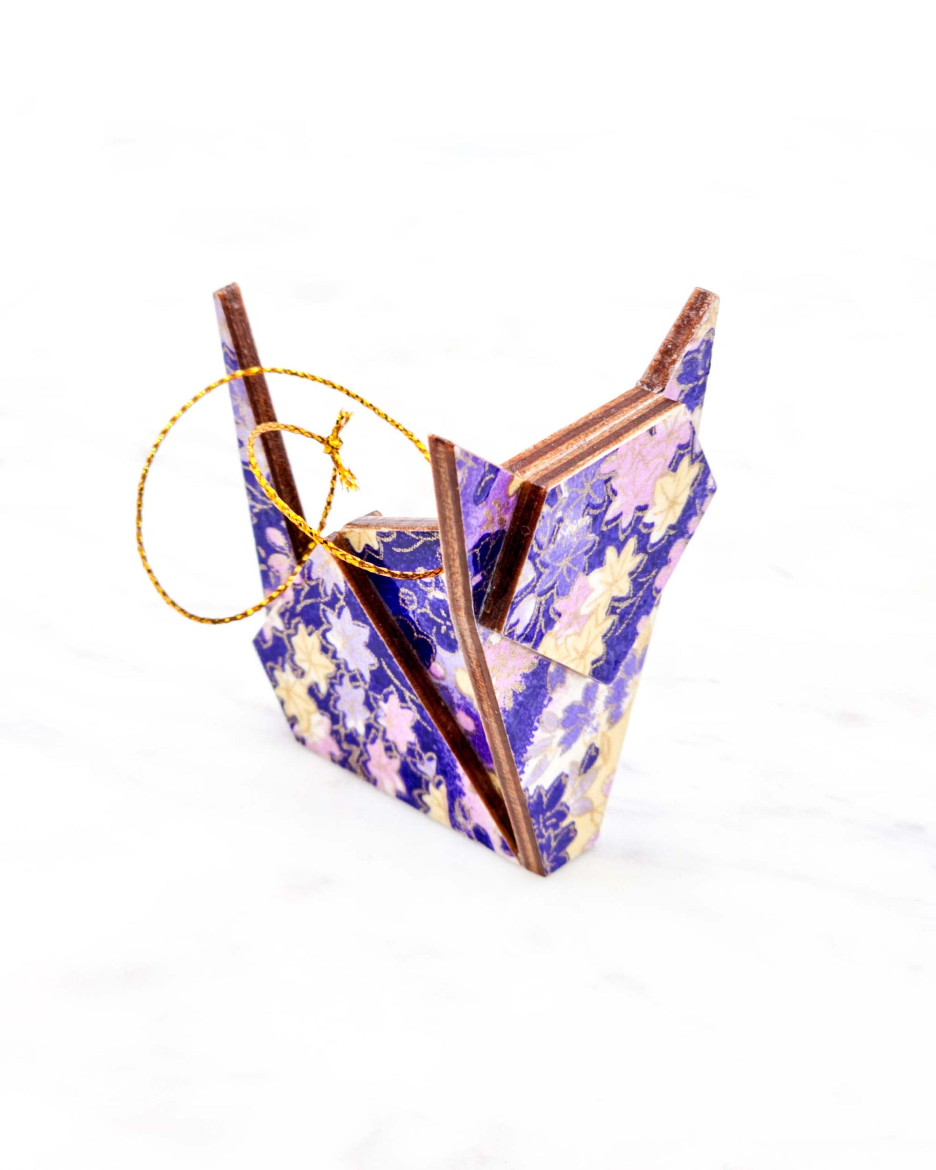 Small wooden origami cat ornament featuring purple and yellow flowers and maple leaves on a purple and white background with metallic gold details.