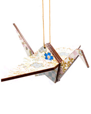 Wooden origami crane ornament featuring blue and silver cherry blossoms and blue and purple ichimatsu pattern on a white background with metallic gold accents.