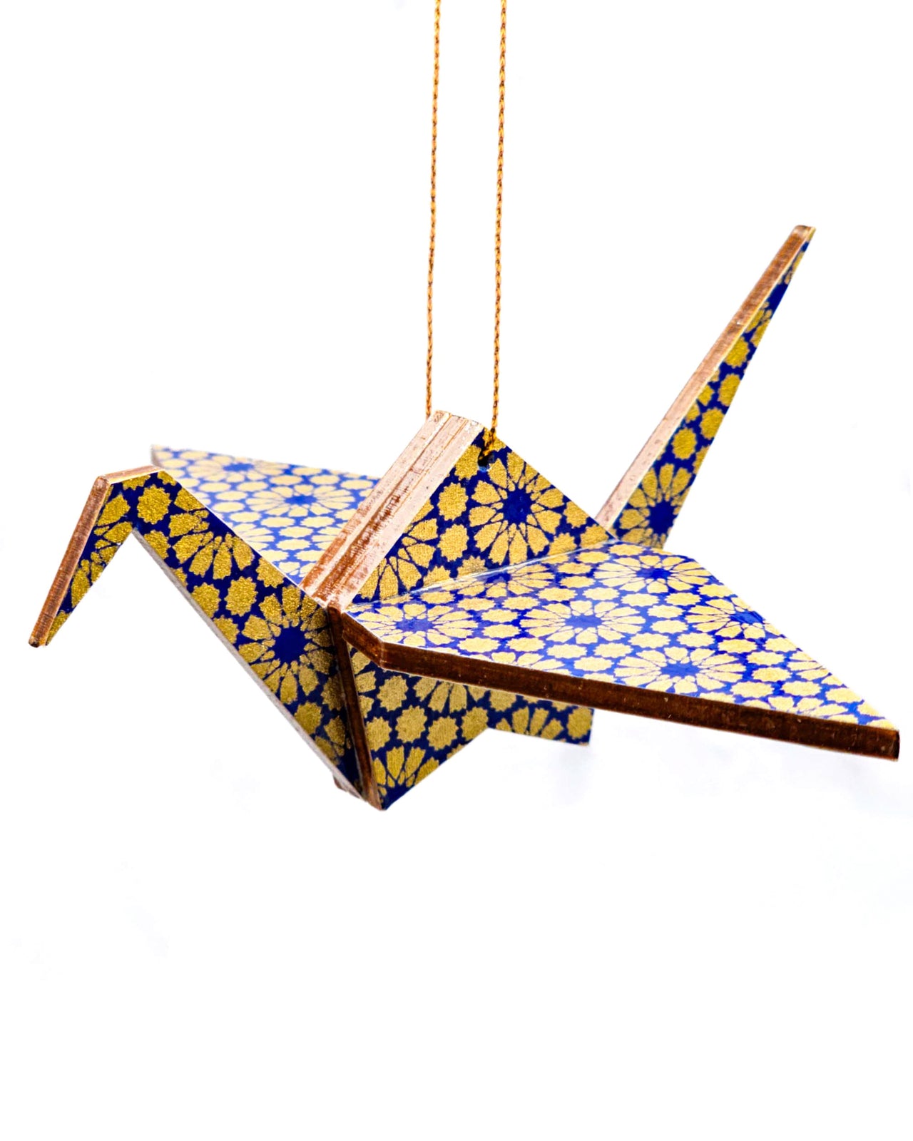 Wooden origami crane ornament featuring metallic gold geometric circles on a dark blue background.