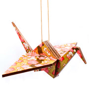 Wooden origami crane ornament featuring pink plum blossoms on metallic gold background.