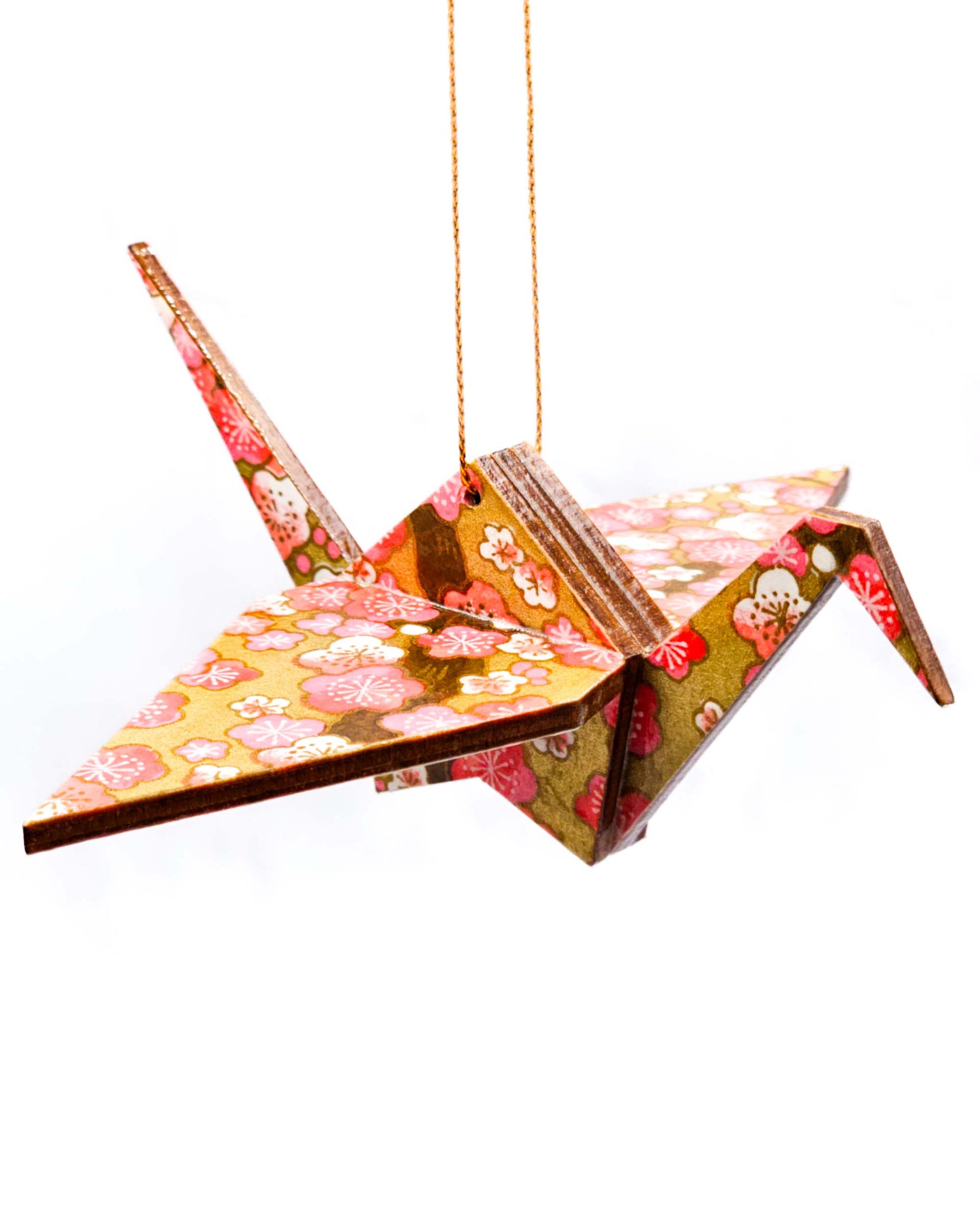 Wooden origami crane ornament featuring pink plum blossoms on metallic gold background.