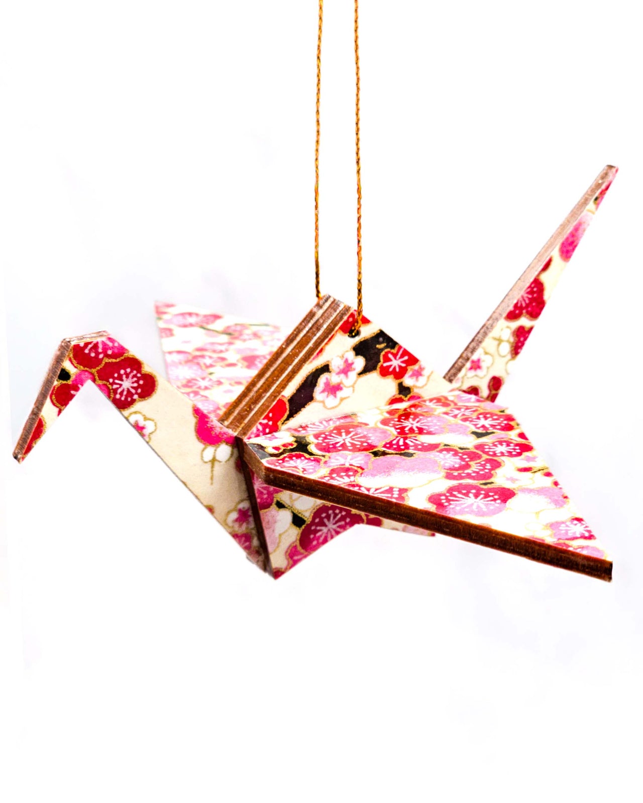 Wooden origami crane ornament featuring pink and white plum blossoms on a light cream background with metallic gold accents.