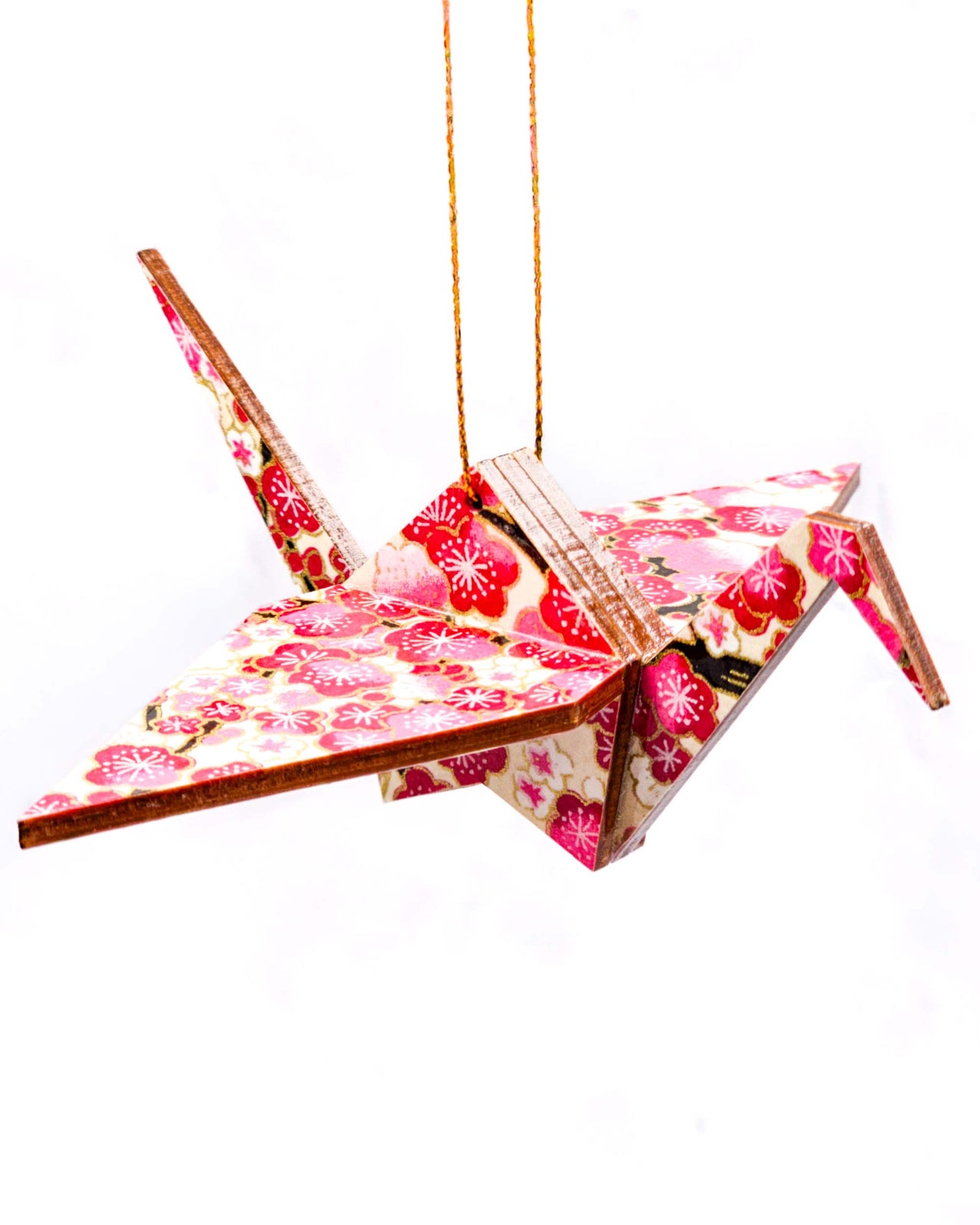 Wooden origami crane ornament featuring pink and white plum blossoms on a light cream background with metallic gold accents.