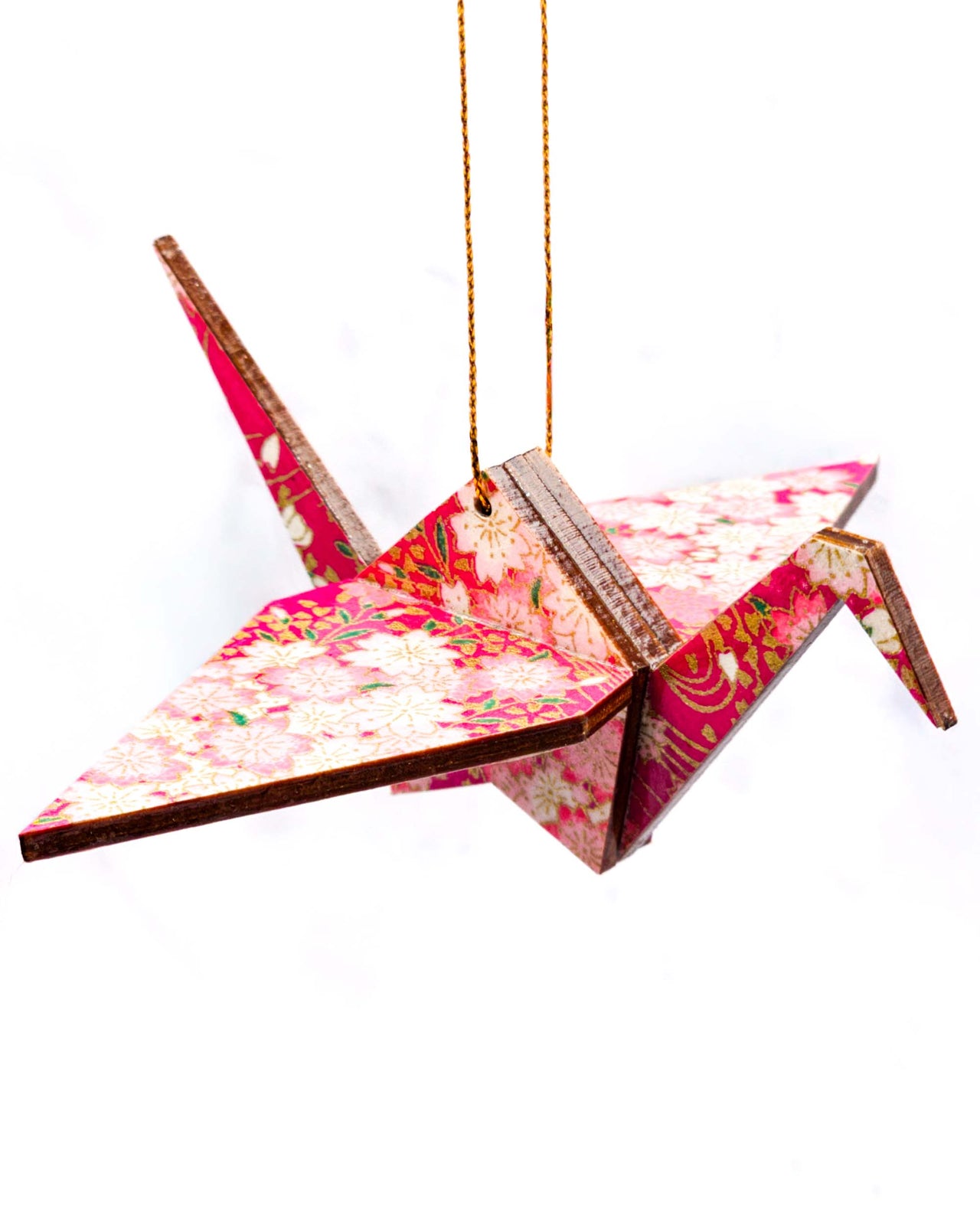 Wooden origami crane ornament featuring pink and white cherry blossoms on a magenta pink background with metallic gold accents.
